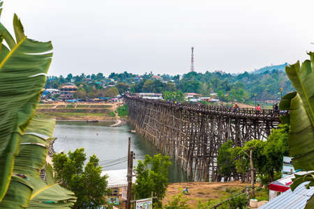 SAGKLABURI THAILAND- MARCH 10 : Unidentified tourists are walking cross the longest wood bridge of Thailand on March 10, 2016 at Mon Bridge.のeditorial素材