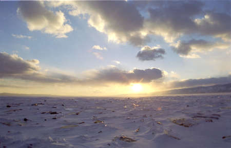 Ice floe and sun on winter Baikal lakeの写真素材