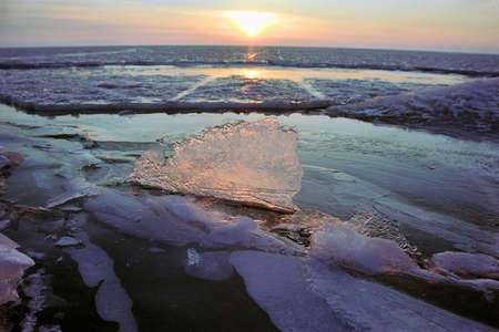 Ice floe and sun on winter Baikal lakeの写真素材