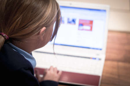 Child using a laptop for homework