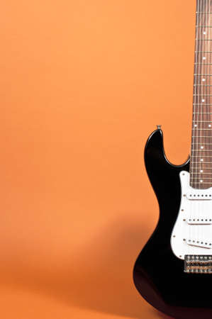 Electric guitar on orangeの写真素材
