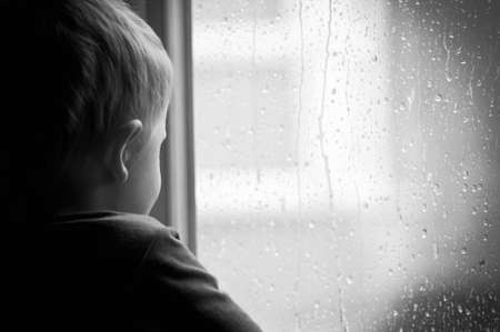 Boy at the windowの写真素材