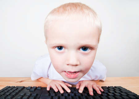 Child looking at computer screenの写真素材
