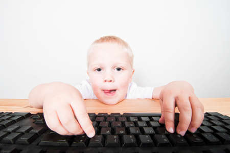 Child typing on keyboardの写真素材