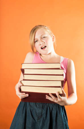 Girl carrying a stack of books