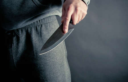 Robber thrusting a knifeの写真素材