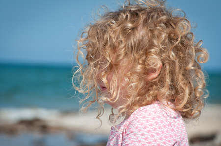 Little girl looking out to seaの写真素材
