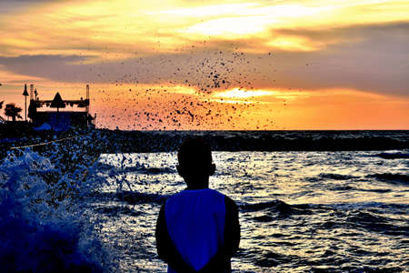 Child, wave and seaの写真素材