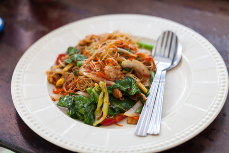Drunken noodles fried with pork in white diskの写真素材