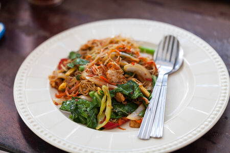 Drunken noodles fried with pork in white diskの写真素材