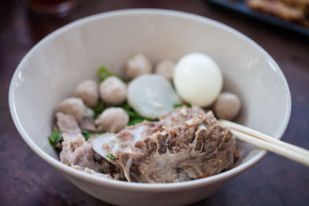 Thai noodles with  pork and Pork meatballs in white diskの写真素材