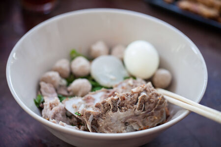 Thai noodles with  pork and Pork meatballs in white diskの写真素材