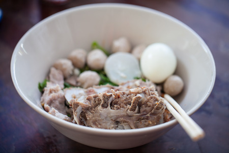 Thai noodles with  pork and Pork meatballs in white diskの写真素材