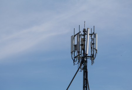 Telecommunication tower in cloudy sky in the backgroundの写真素材