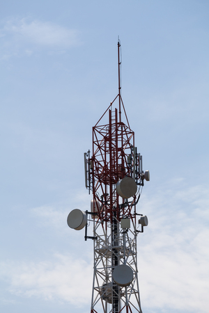 Telecommunication tower in cloudy sky in the backgroundの写真素材