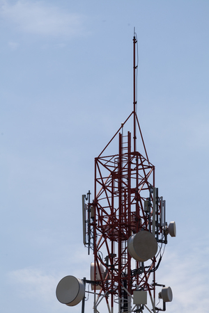 Telecommunication tower in cloudy sky in the backgroundの写真素材