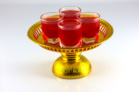 golden ware and small glass isolate in white backgroundの写真素材