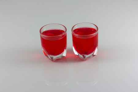 a glass of red water isolate in white backgroundの写真素材