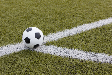 Soccer ball on green fieldの写真素材