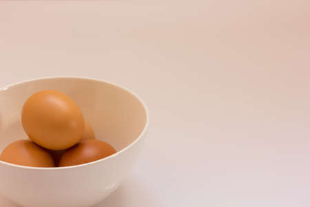 Eggs in white bowl isolate in white backgroundの写真素材