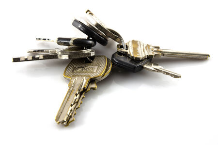 Large bunch of keys isolate on white backgroundの写真素材