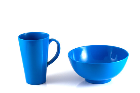 Blue disk and green cup isolate on white backgroundの写真素材