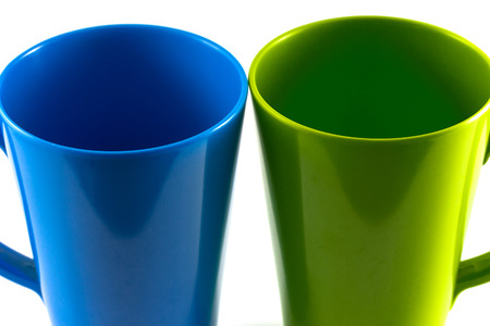 Green and blue cup isolate on white backgroundの写真素材