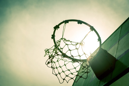 Wooden basketball hoop during sunset.の写真素材