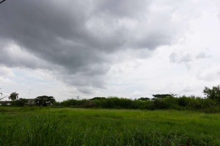 Dark sky sun still shining. Storm comingの写真素材