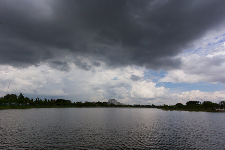 Dark sky sun still shining. Storm comingの写真素材