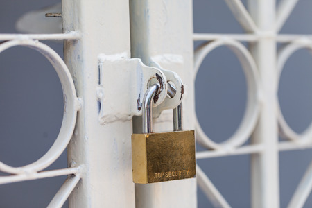 Padlocks white fence in the morningの写真素材