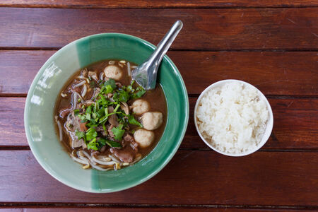 bowl of pungent thai pork noodle soup with riceの写真素材