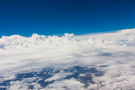 Blue sky with clouds background on the airplan in the morning timeの写真素材