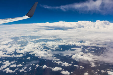 Blue sky with clouds background on the airplan in the morning timeの写真素材