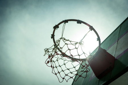 Wooden basketball hoop during sunset.の写真素材