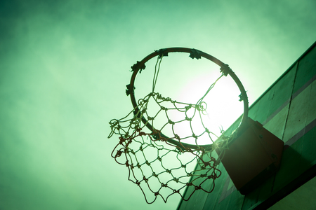Wooden basketball hoop during sunset.の写真素材