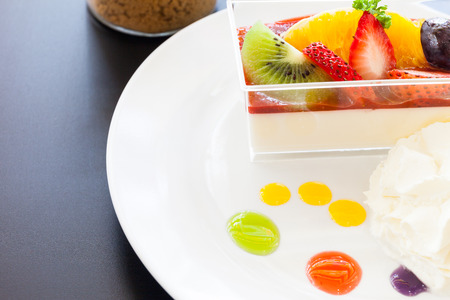 strawberry cream and a cup of tea and cofee on a wooden background, selective focusの写真素材