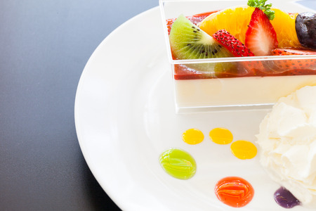 strawberry cream and a cup of tea and cofee on a wooden background, selective focusの写真素材