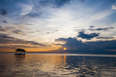 Pontoon floating in the water at sunsetの写真素材