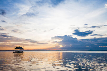Pontoon floating in the water at sunsetの写真素材