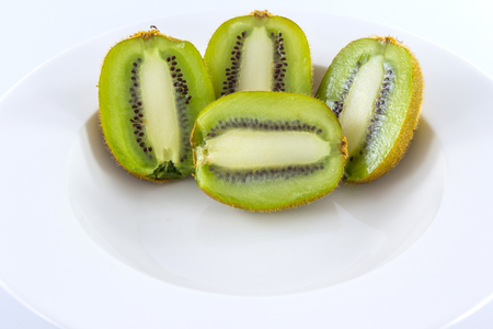 Kiwi fruit  on white disk on white background, macroの写真素材