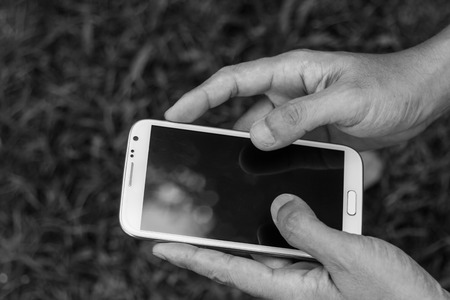 Close up man using mobile smart phone green backgroundの写真素材