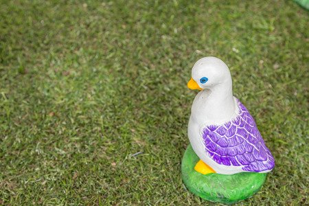 Ceramic ducks  handmade decoration on green grassの写真素材