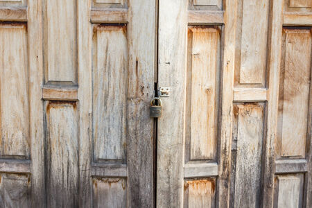 Old weathered wooden door made from planks. With  lockの写真素材