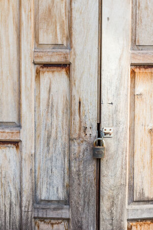 Old weathered wooden door made from planks. With  lockの写真素材