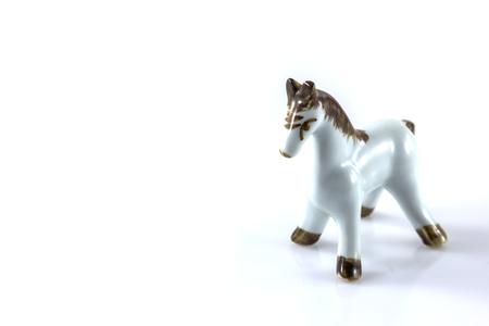 white ceramic figurine of a horse on a white backgroundの写真素材