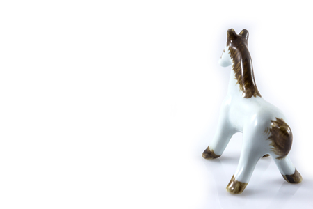 white ceramic figurine of a horse on a white backgroundの写真素材