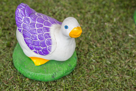 Ceramic ducks  handmade decoration on green grassの写真素材