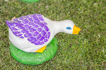 Ceramic ducks  handmade decoration on green grassの写真素材