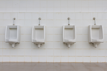 white urinals in men's bathroomの写真素材